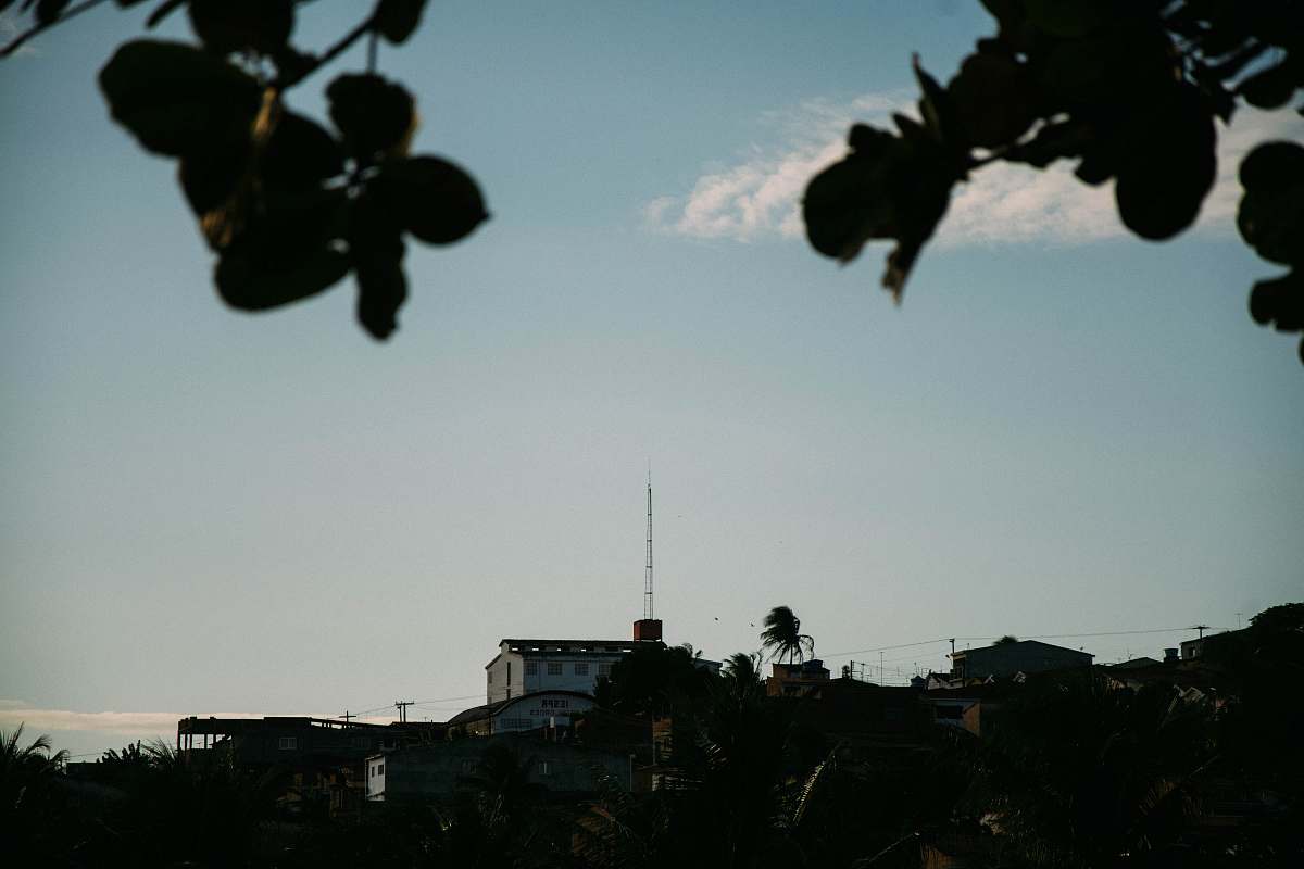 grey white house beside tower under cloudy sky during daytime antenna